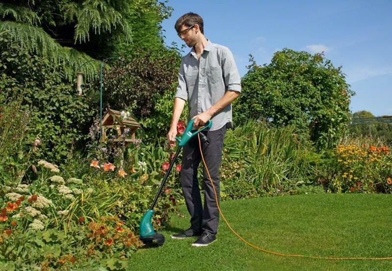 Electric strimmer in use in the garden